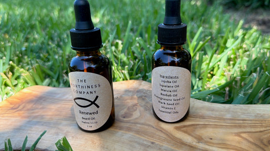 Two amber glass dropper bottles of  The Worthiness Company Renewed Beard Oil