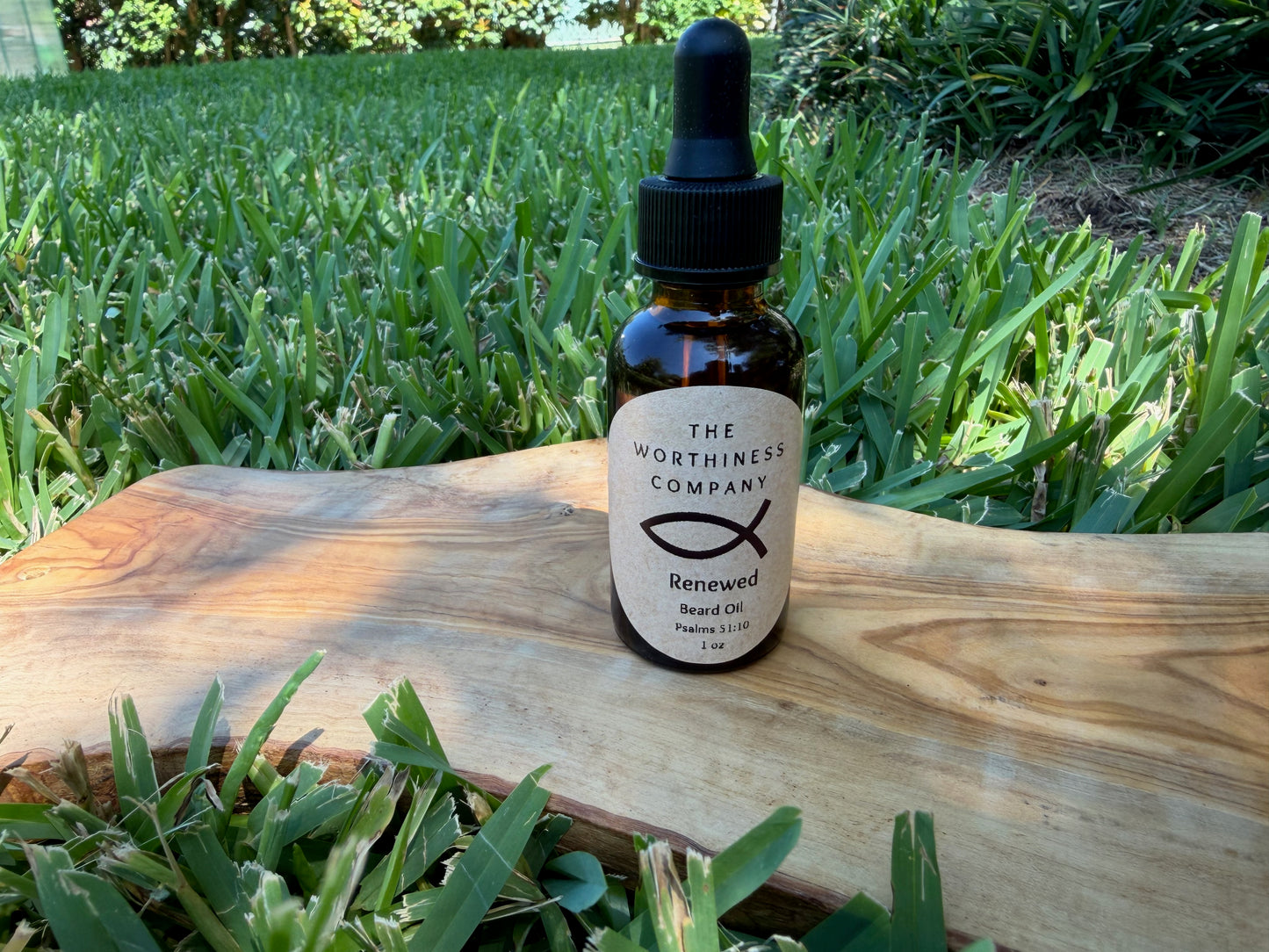 Two amber glass dropper bottles of  The Worthiness Company Renewed Beard Oil