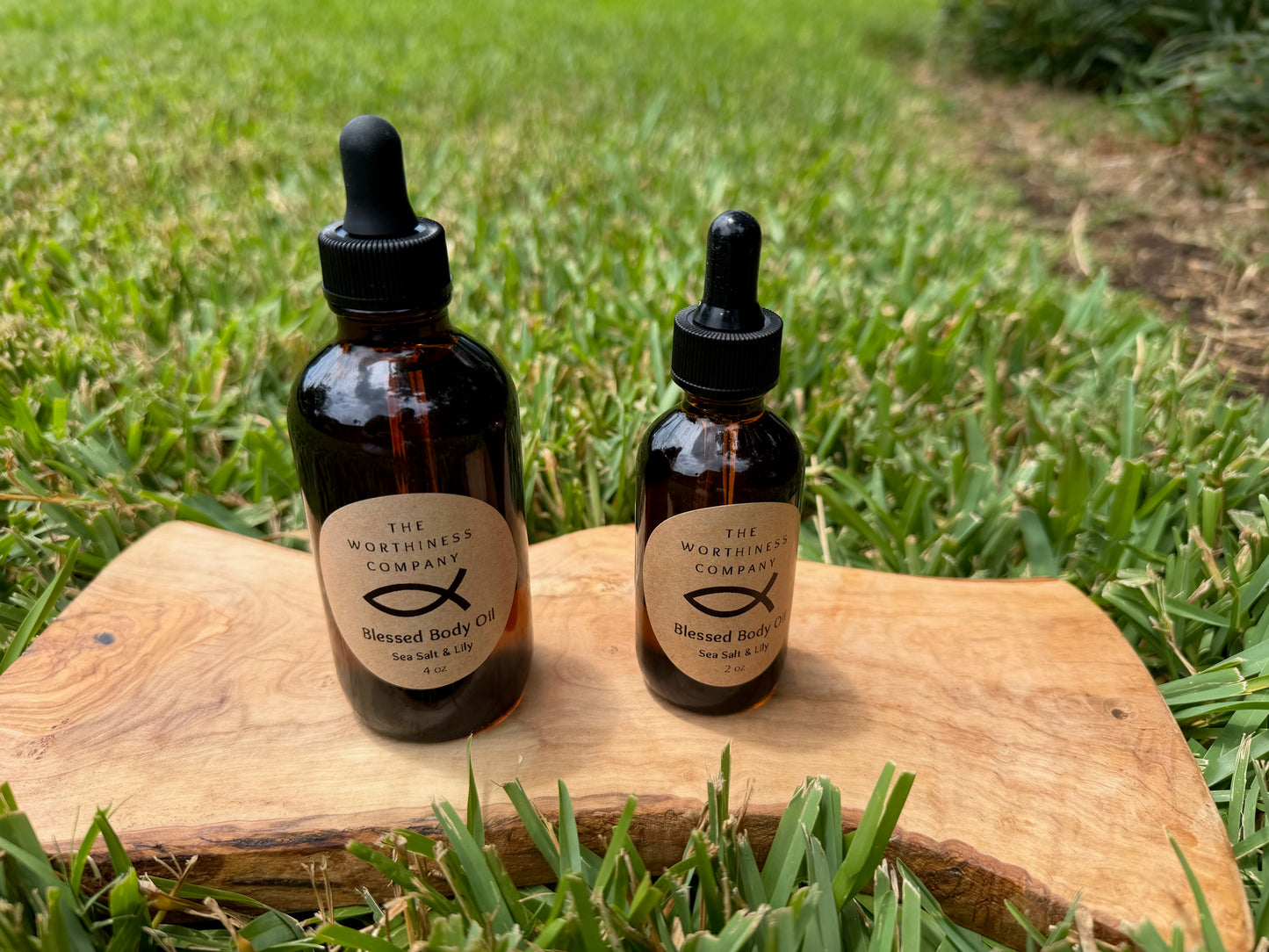 Two amber glass dropper bottles of Blessed Body Oils by The Worthiness Company.