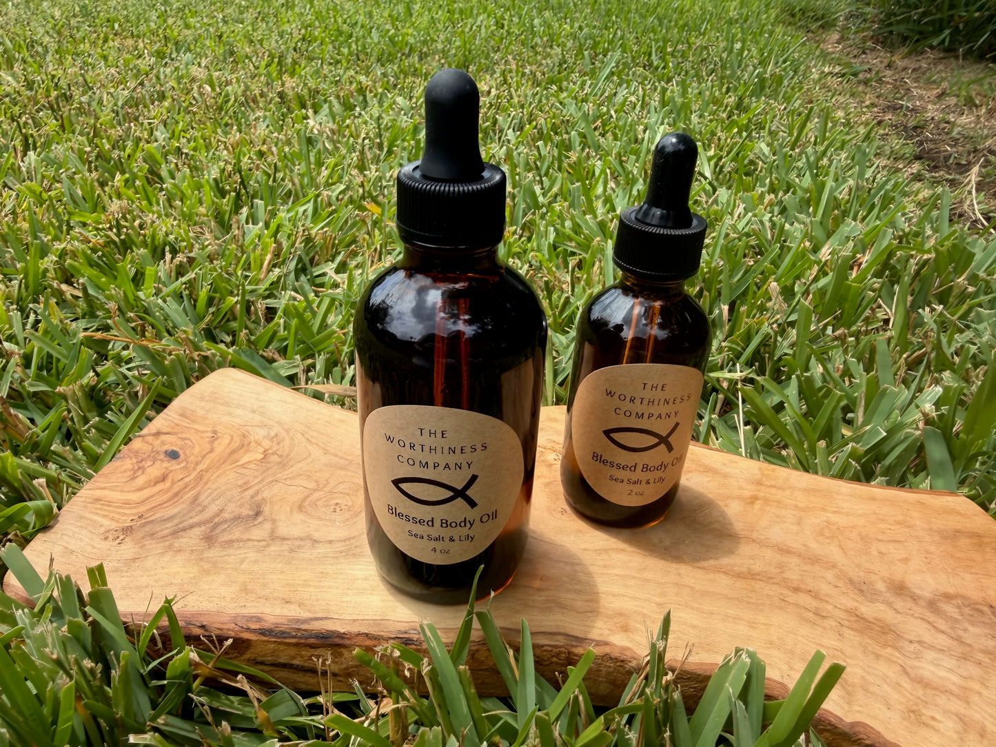 Two amber glass dropper bottles of Blessed Body Oils by The Worthiness Company.