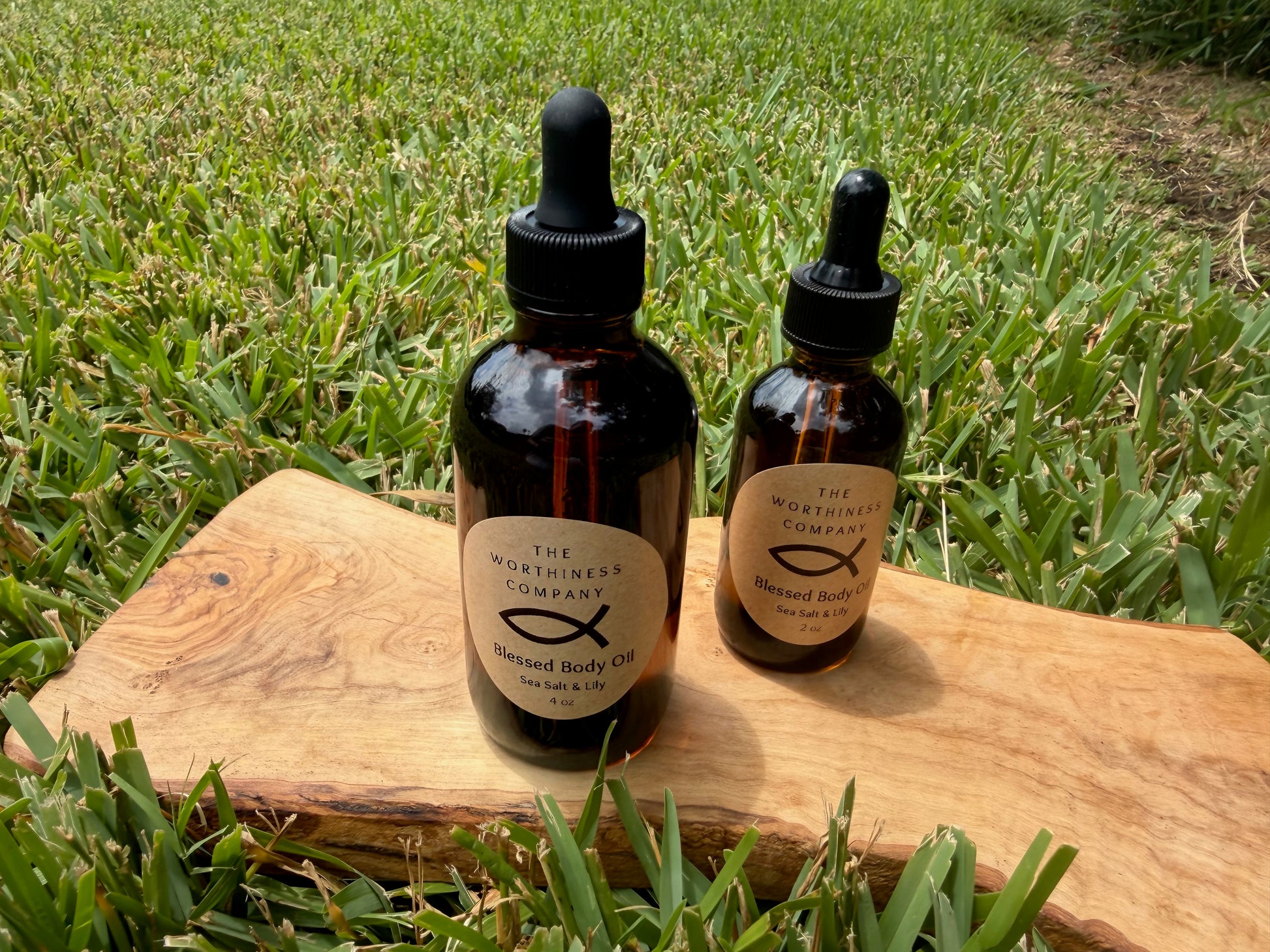 Two amber glass dropper bottles of Blessed Body Oils by The Worthiness Company.