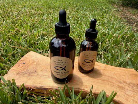 Two amber glass dropper bottles of Blessed Body Oils by The Worthiness Company.