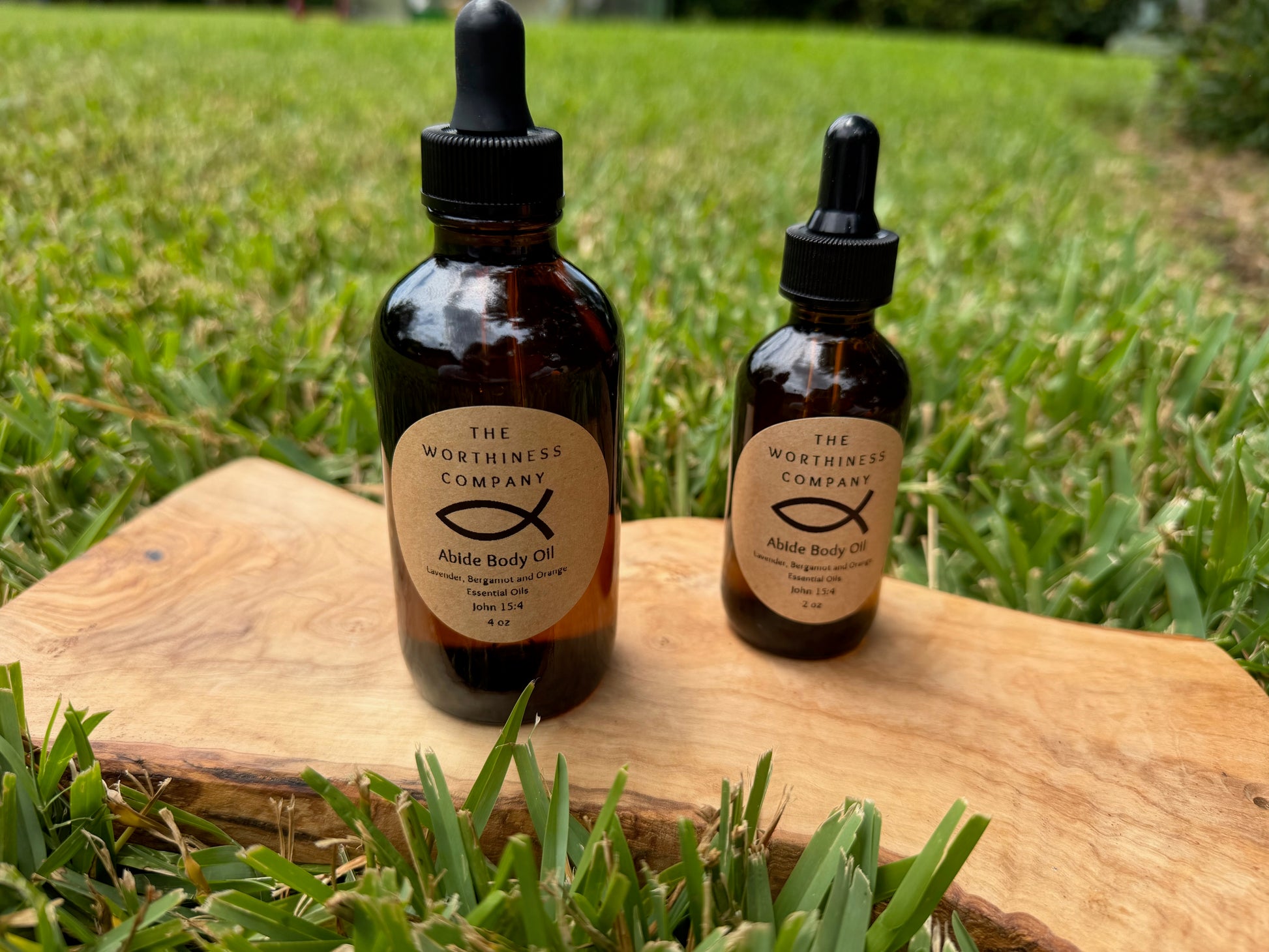 Two amber glass dropper bottles of Abide Premium Body Oils by The Worthiness Company.