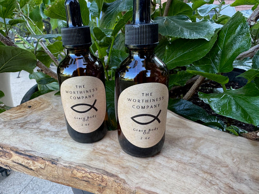 Two amber glass dropper bottles of Grace Body Oils by The Worthiness Company.